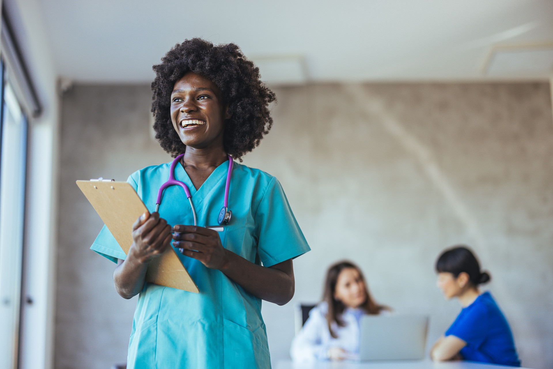 Smiling Nurse Holding Clipboard in a Medical Office